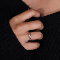 round cut side stone in rose gold ring design.