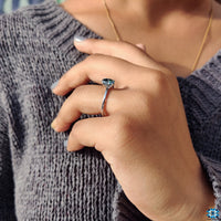 Greenish blue stone ring in a stunning oval cut, set in white gold.