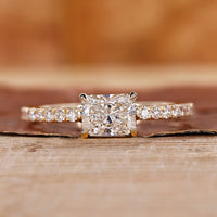 Radiant cut engagement ring in east to west setting.