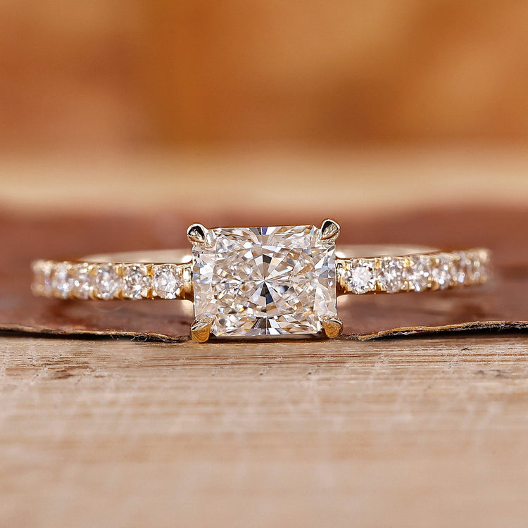 Radiant cut engagement ring in east to west setting.