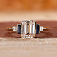 5 stone ring with emerald cut diamond and baguette side stones.