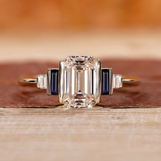 5 stone ring with emerald cut diamond and baguette side stones.