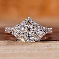 Two tone engagement ring with east west marquise diamond setting.