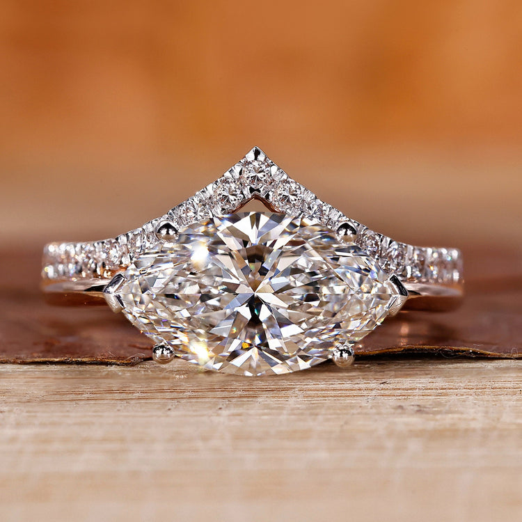 Two tone engagement ring with east west marquise diamond setting.