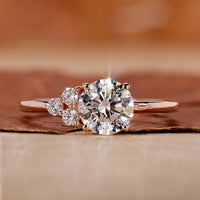 asymmetrical engagement ring with round cut side stone.