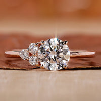 asymmetrical engagement ring with round cut side stone.