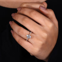 Oval shaped diamond engagement ring with marquise side stones.