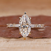 Marquise diamond engagement ring with pave setting ring.