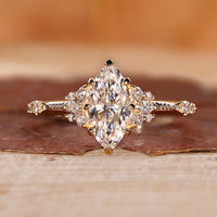 Marquise engagement ring with round side diamond.