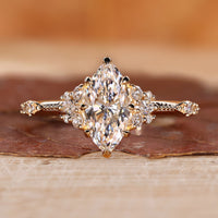 Marquise engagement ring with round side diamond.