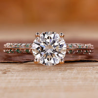 Knife edge ring with round cut diamond and pavé setting in rose gold.