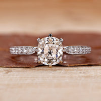 Old mine cushion cut diamond ring with pave setting ring.
