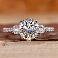 3 stone diamond ring with round cut diamonds in white gold.