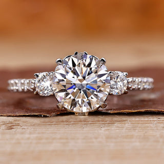 3 stone diamond ring with round cut diamonds in white gold.