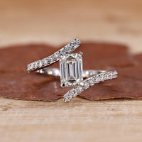 Emerald engagement ring crafted in a bypass setting with a modern twist.