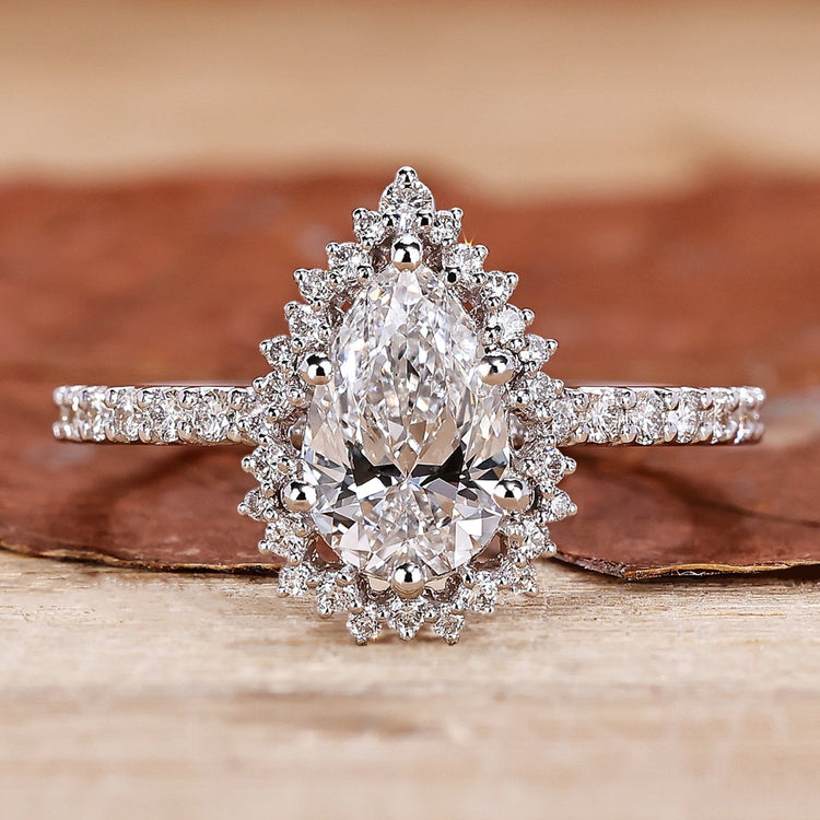 pear shaped diamond ring in pave setting style.