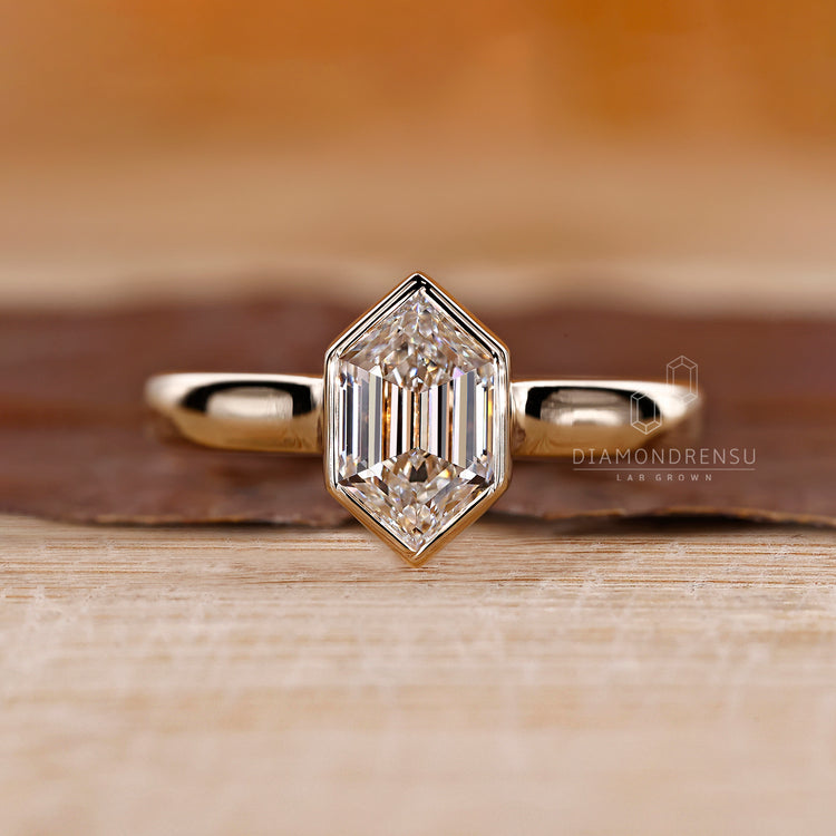 Hexagon solitaire ring with cathedral setting.
