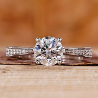 round diamond engagement ring with cathedral setting ring.