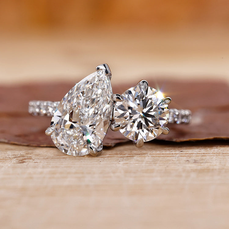 Toi Et Moi engagement ring with pear and round diamonds in white gold.