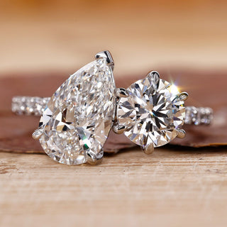 Toi Et Moi engagement ring with pear and round diamonds in white gold.