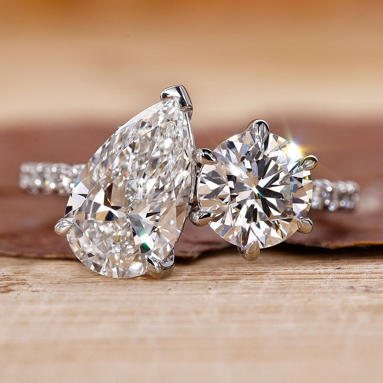 Toi Et Moi engagement ring with pear and round diamonds in white gold.