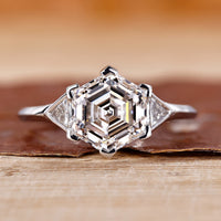 Hexagon engagement ring with triangle side stone.