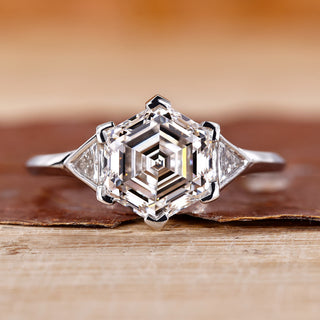 Hexagon engagement ring with triangle side stone.