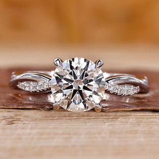 Round diamond engagement ring in a white gold twisted pave ring setting.