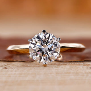 Yellow gold solitaire engagement ring with a round cut diamond centre.