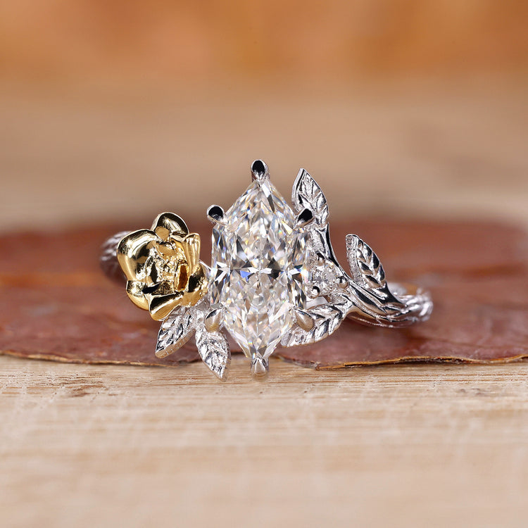 Nature inspired engagement ring with Dutch marquise diamond and round side stones.