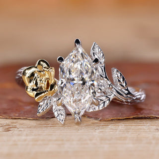 Nature inspired engagement ring with Dutch marquise diamond and round side stones.