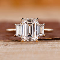 Three stone emerald cut ring with emerald diamond ring.