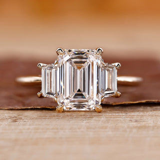 Three stone emerald cut ring with emerald diamond ring.
