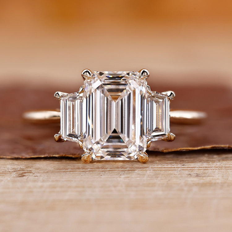Three stone emerald cut ring with emerald diamond ring.