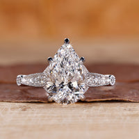 Vintage diamond ring with pear cut diamond and round side stones.