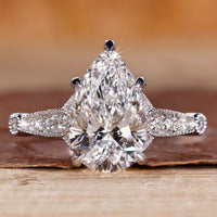 Vintage diamond ring with pear cut diamond and round side stones.