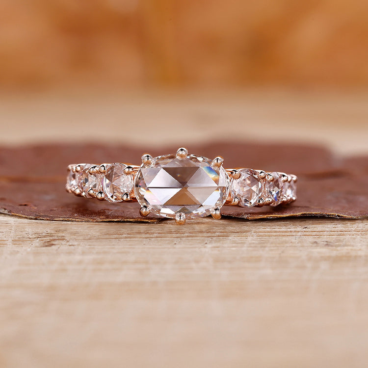 Rose gold diamond ring with oval rose cut diamond and tapered pavé setting.