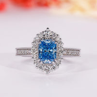 Blue diamond ring with radiant cut engagement ring.