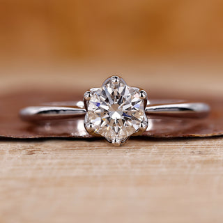 Round cut diamond ring in tulip setting ring.