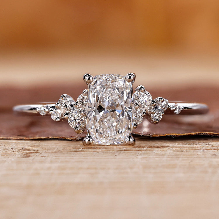 Elongated cushion cut diamond ring set in a white gold band.