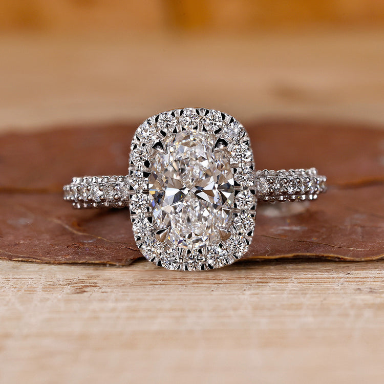 Oval diamond engagement ring with halo ring setting.