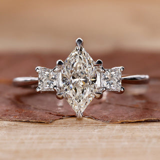 3 stone engagement ring with princess cut side stones.