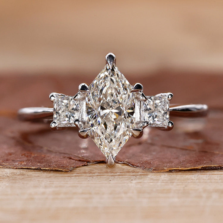 3 stone engagement ring with princess cut side stones.