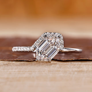 Hexagon cut engagement ring with round cut side stone.