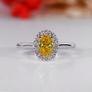 Halo diamond ring with oval center stone.