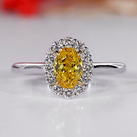 Halo diamond ring with oval center stone.
