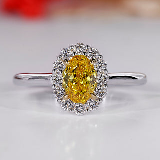 Halo diamond ring with oval center stone.