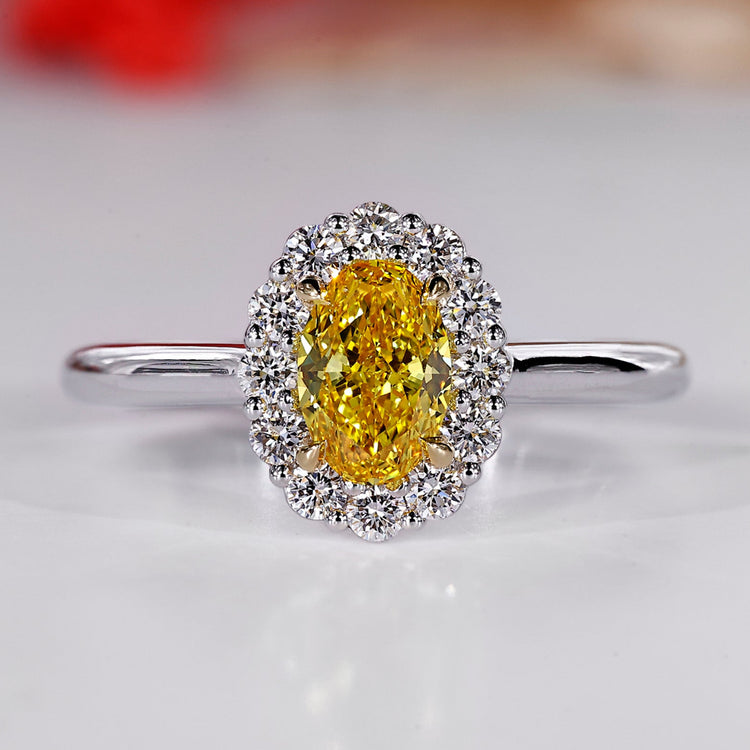 Halo diamond ring with oval center stone.