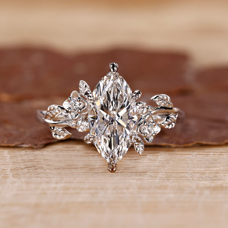 Marquise cut diamond ring with round side stones.