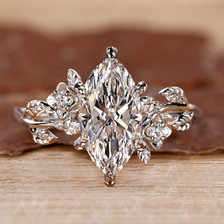 Marquise cut diamond ring with round side stones.